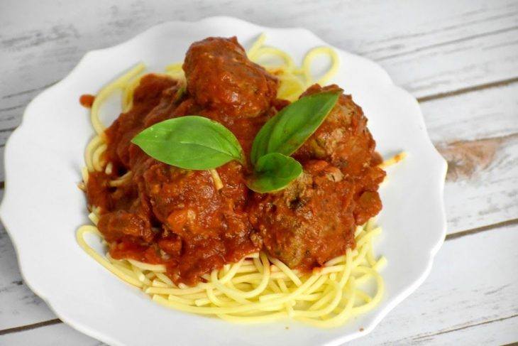Meatballs on a plate on top of gluten free spaghetti