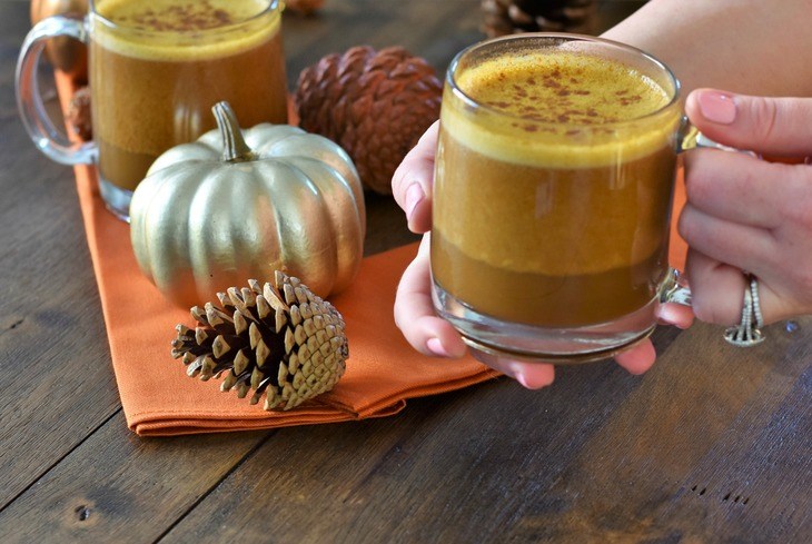 Dairy Free Pumpkin Spice Latte in a mug being held