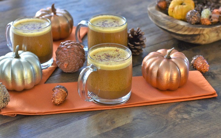 Dairy Free Pumpkin Spice Latte in mugs on a table with pumpkins