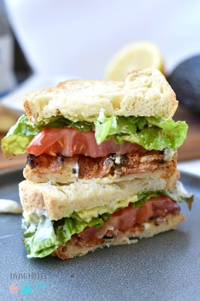 Gluten free BLT sandwich cut in half on a plate