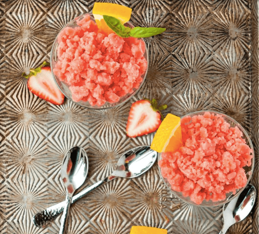 strawberry orange granita in bowls with spoons