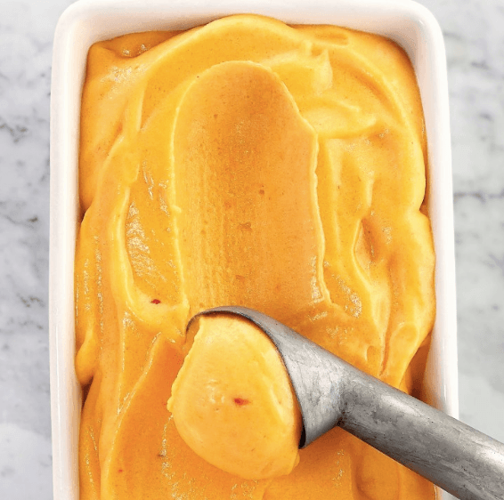 peach sorbet being scooped