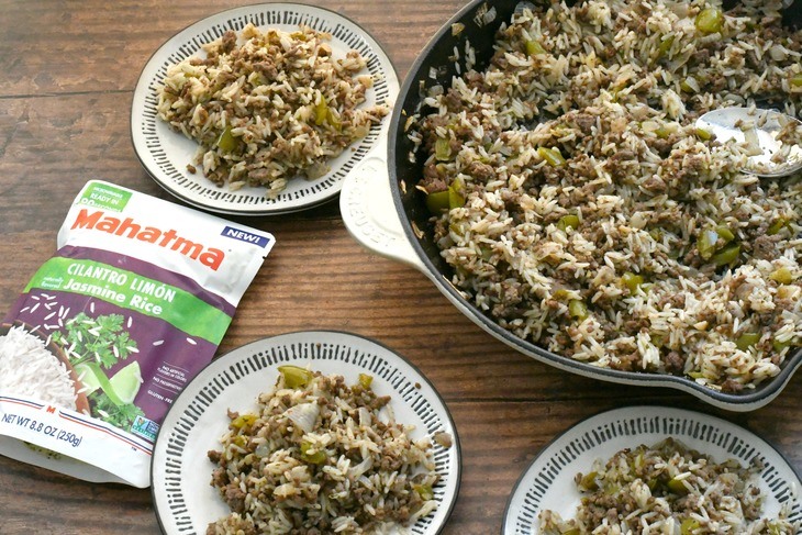 Mexican dirty rice in a pan and served on plates on a table