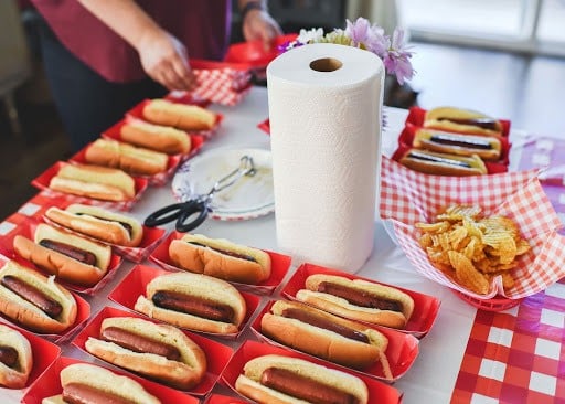 hot dogs on a table and paper towels