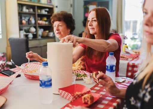 grabbing a paper towel at the table