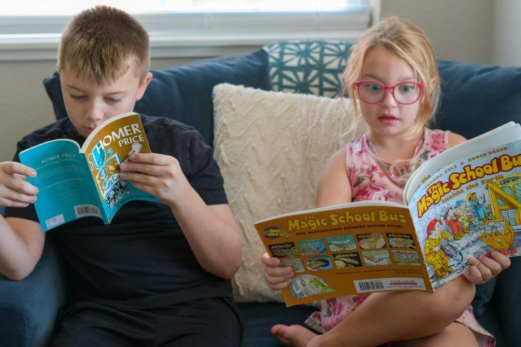 kids reading books from the bookshark science curriculum 