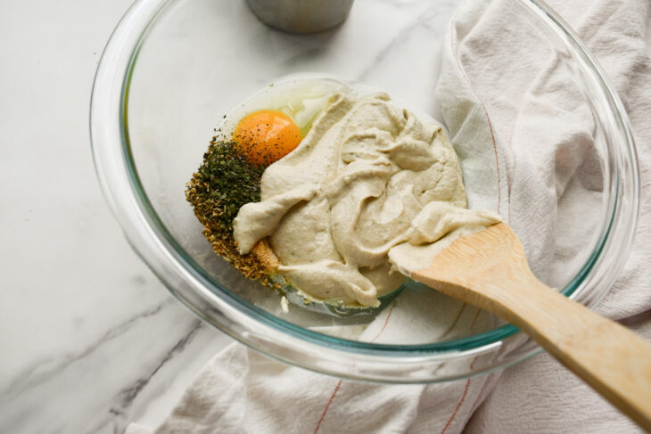 In a medium sized bowl combine the ricotta or cashew cream, ½ cup of mozzarella, ½ cup of parmesan, egg plus the salt, granulated garlic, parsley, pepper, basil and oregano. Stir well to combine. Set aside.