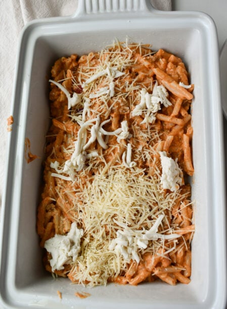 Pour ½ of  the pasta into a lightly grease large baking casserole, sprinkle with half of your remaining cheese.
